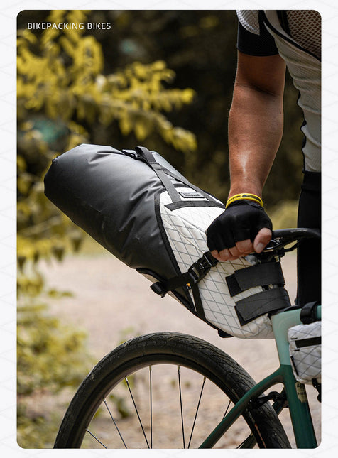 Cyclist loading the 14L dry bag into its harness
