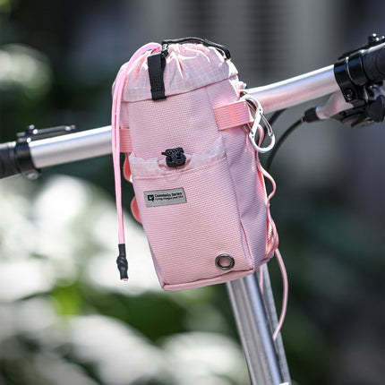 Cosmopolis bike bottle bag on a bicycle handlebar
