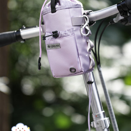 Nebula Purple Cosmopolis bike bottle bag mounted on a handlebar